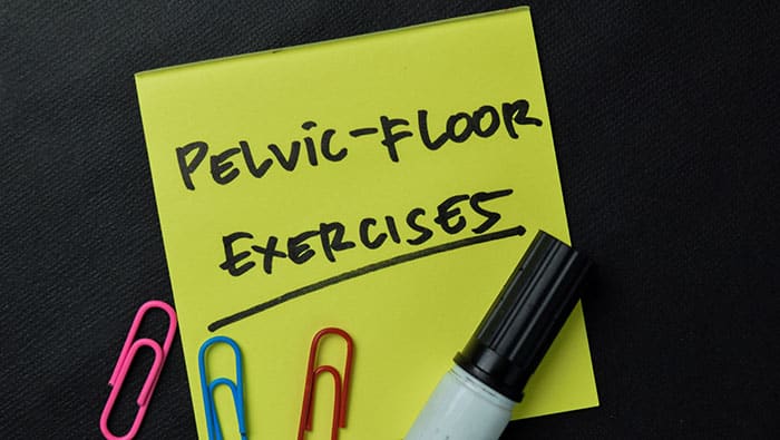 Pelvic-Floor Exercises write on sticky notes isolated on office desk.