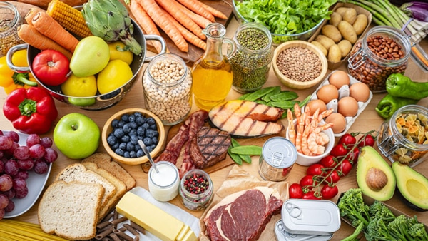 Table filled with large variety of food including carbohydrates, dietary fiber and proteins