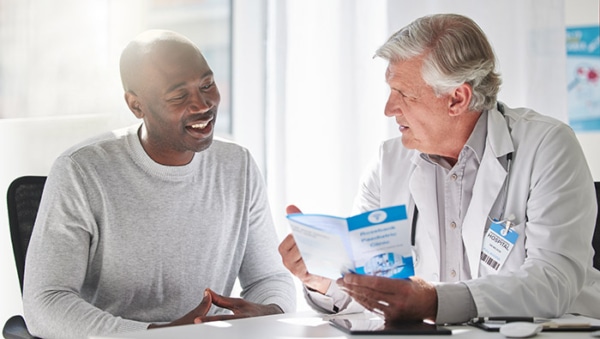 Patient and doctor reviewing PSA test scores to indicate prostate cancer risk. 